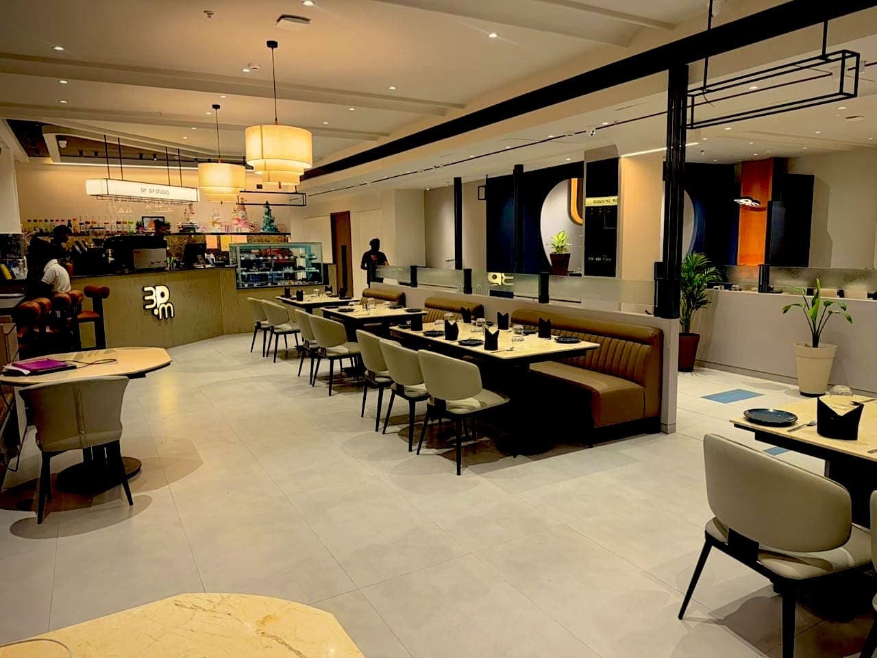 Coffee counter with the 3PM logo and long banquette seating